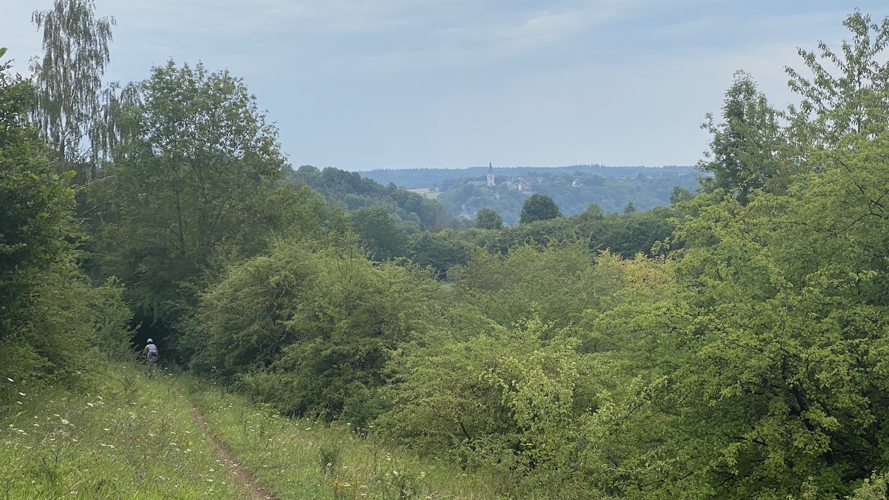 Mountainbike trail with village in the distance